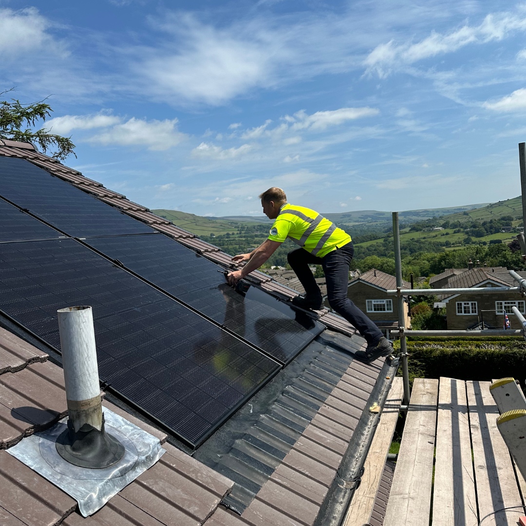 Apex Doma Wiping Solar Panels on a Roof
